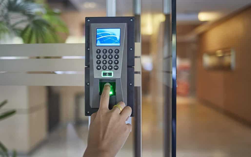 Person scanning their finger on a door access control system