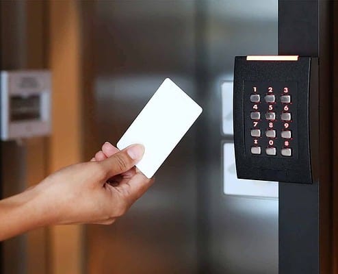 Door access control - young woman holding a key card to lock and unlock door_