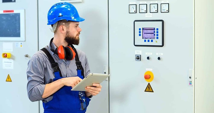 sideview of working checking building automation system with tablet