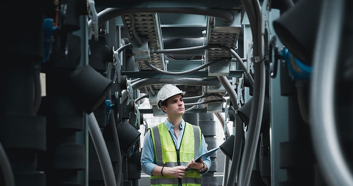 worker inspecting hvac unit