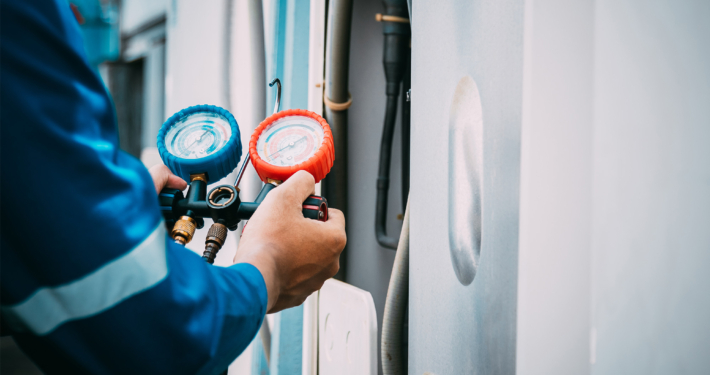 Technician is checking air conditioner refrigerant leak
